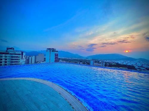 a large swimming pool on top of a city skyline at Grand Tourane Nha Trang Hotel in Nha Trang