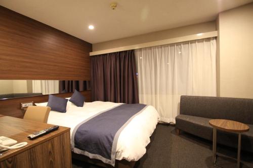 Postel nebo postele na pokoji v ubytování Hotel Il Credo Gifu