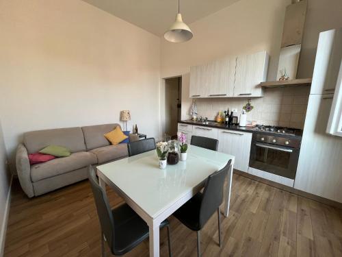 a kitchen and living room with a table and a couch at Casa Viesseux in Florence