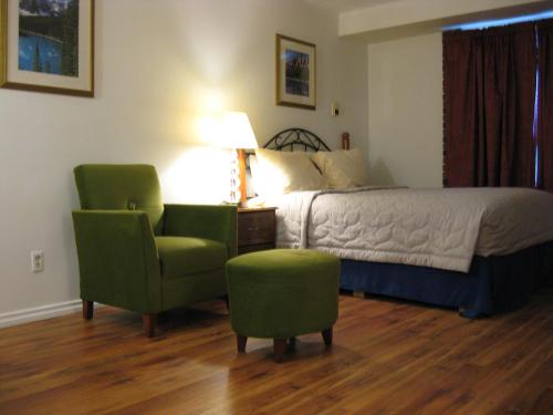 a bedroom with a bed and a chair and a table at Royal City Motor Inn in Brooks