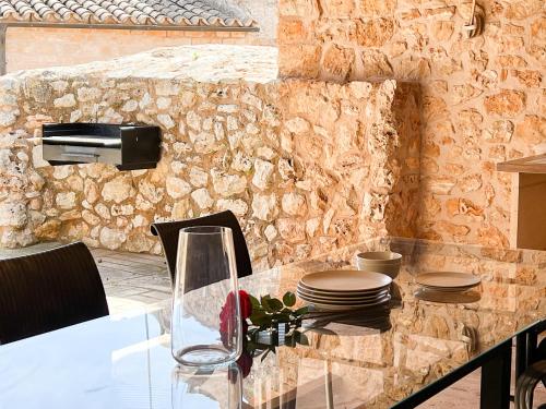 een eettafel met borden en gerechten op een stenen muur bij Villa Petita Llombards in Llombarts