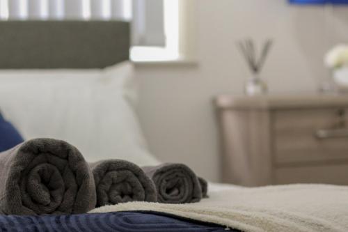 a close up of a bed with towels on it at Modern Bradford City Apartment in Bradford