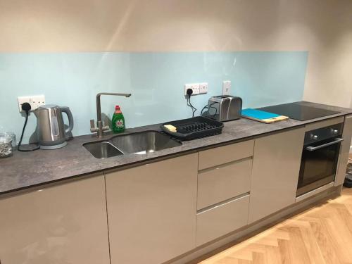 a kitchen with a sink and a counter top at Rural Devon retreat in stunning Exe Valley. in Exeter