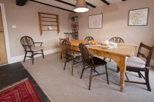 a dining room with a wooden table and chairs at The Old White Lion, Chapel Stile in Chapel Stile