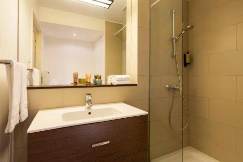 a bathroom with a sink and a shower at Citadines Part-Dieu Lyon in Lyon