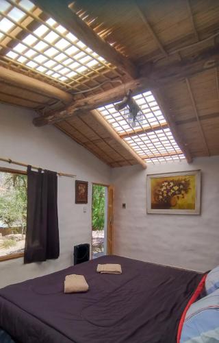 a bedroom with a bed with two towels on it at Dormir con llamas in Maimará