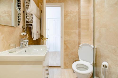 a bathroom with a toilet and a sink at Beresford Road London Rooms in London