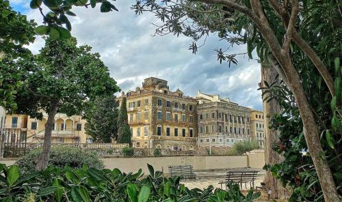 a large building with benches in front of it at Villa Maria (3) in Paleokastritsa