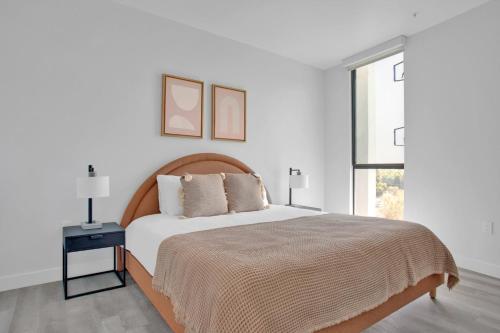 a white bedroom with a large bed and a window at Hollywood 2BR w Roof BBQ nr MelroseFairfax LAX-890 in Los Angeles