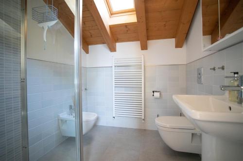 a bathroom with a toilet and a sink and a shower at IseoLakeRental - Casa Amata in Riva di Solto