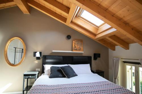a bedroom with a bed and a vaulted ceiling at IseoLakeRental - Casa Amata in Riva di Solto
