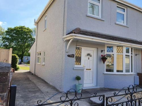 a house with a bench in front of it at Mellte Avenue - Waterfalls House in Pont-Nedd-Fechan