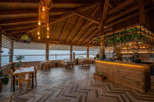 a restaurant with tables and chairs and a bar at Aerial Hotel & Spa in Vlorë