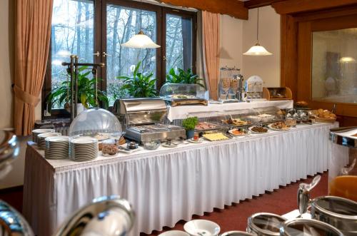 a buffet of food on a white table at Hotel Simonshof in Wolfsburg