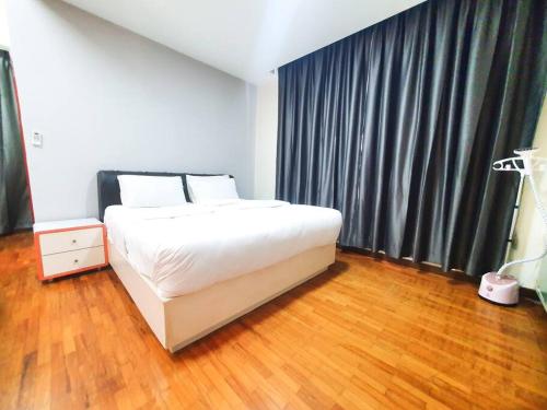 a bedroom with a white bed and a large window at [HERITAGE 7] HOMESTAY Studio 4Pax, FREE WIFI in Seri Kembangan