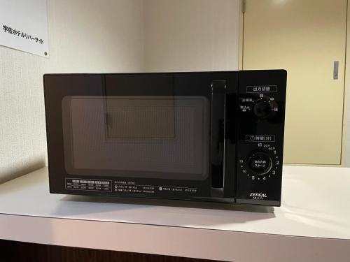 Televisyen dan/atau pusat hiburan di Usa Hotel Riverside