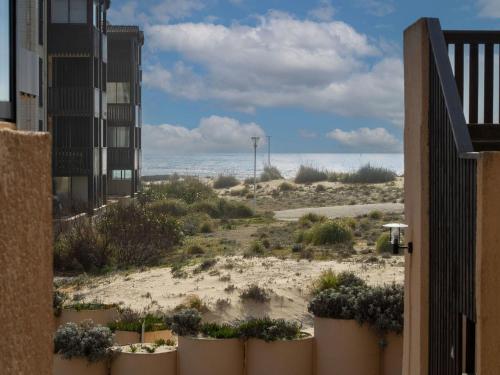 a view of the beach from the balcony of a building at Apartment Les Maisons de l'Océan-9 by Interhome in Lacanau-Océan