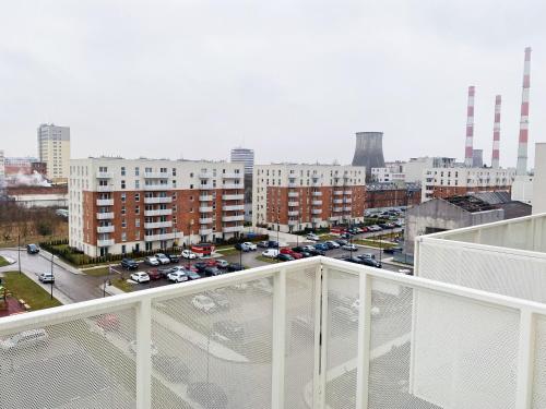 a view of a city from the balcony of a building at IgoAparts Wroblewskiego in Łódź