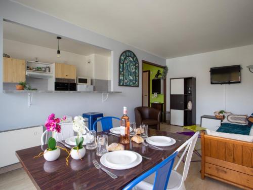 a dining room and kitchen with a table and chairs at Apartment La Pinède-2 by Interhome in Puits