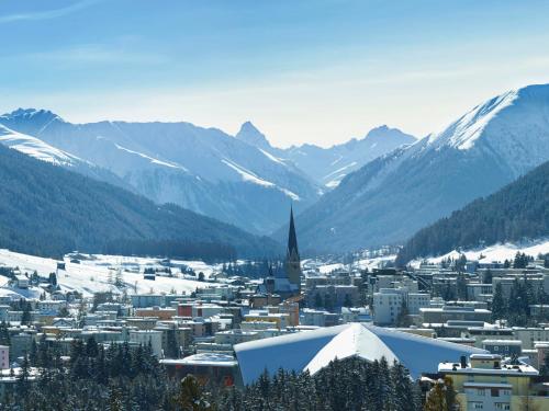 a view of a city with snow covered mountains at Apartment Allod Park Haus C U04 by Interhome in Davos