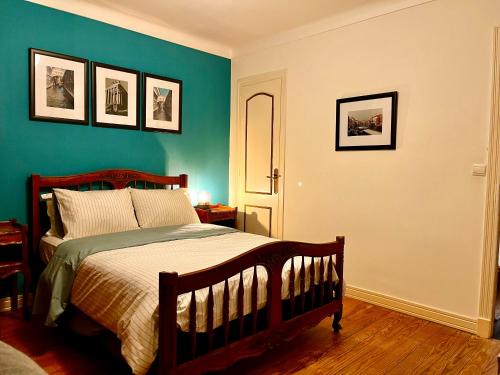 a bedroom with a bed and a green wall at Private Rooms & Bath in Tonneins