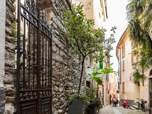 an old stone building with a gate on a street at Apartment Double Room Modern-11 by Interhome in Ascona