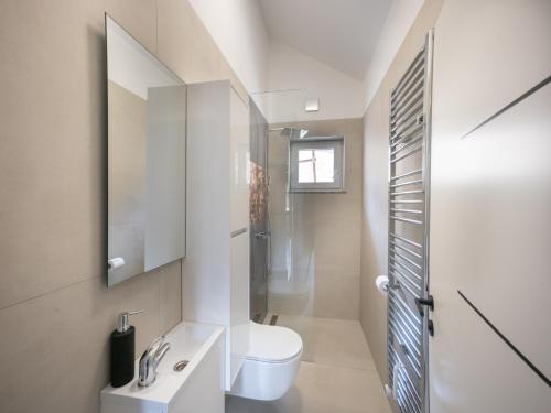 a bathroom with a white toilet and a sink at Resort TimAJA - pool, massage pool, sauna in Trebnje