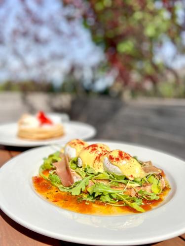 a plate of food with a salad on a table at Rawley Resort, Spa & Marina in Port Severn