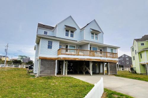 a blue house with a balcony on top of it at Croaker #5A-CAC in Buxton