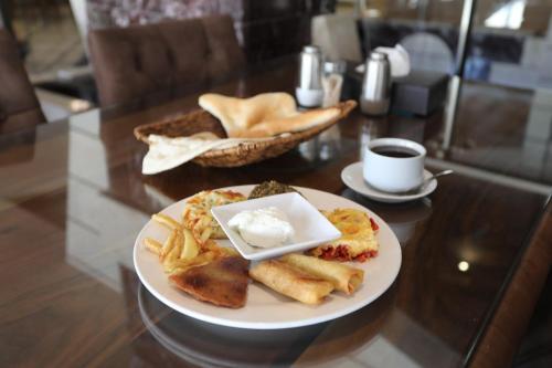 a plate of breakfast food on a table at Royal Eagle Hotel in An Najaf