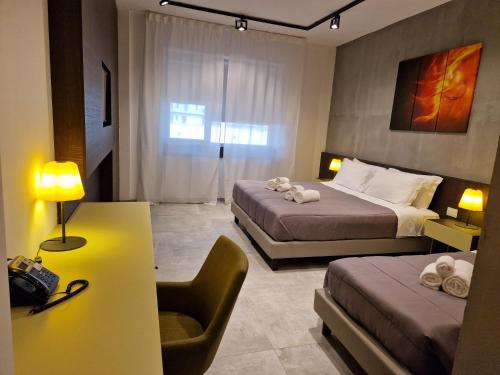 Ένα ή περισσότερα κρεβάτια σε δωμάτιο στο Korè Hotel