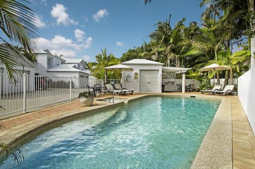 a swimming pool in the backyard of a house at Portside Noosa Waters in Noosaville