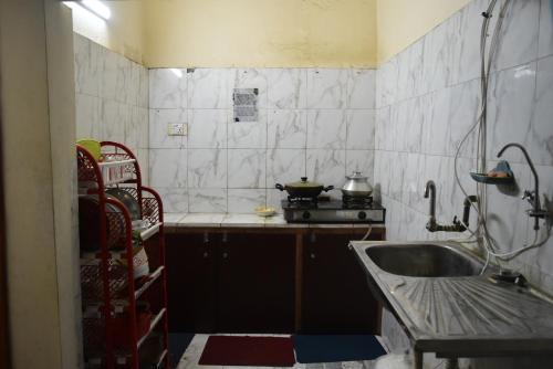 uma pequena cozinha com um lavatório e um fogão em Homestay 2 em Daca