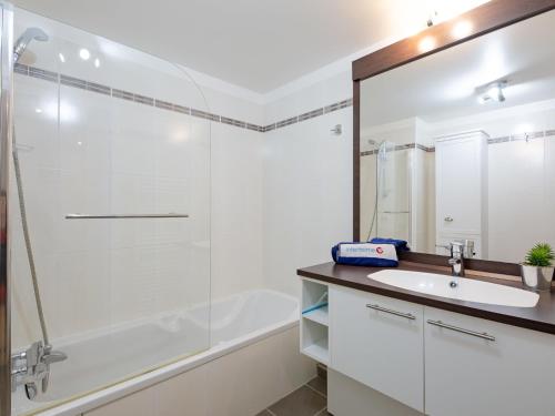 a bathroom with a shower and a sink and a tub at Apartment Les Rivages de L'Esterel-2 by Interhome in Boulouris-sur-Mer