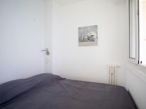 a white room with a bed and a window at Apartment L'Angelina-1 by Interhome in Cros-de-Cagnes