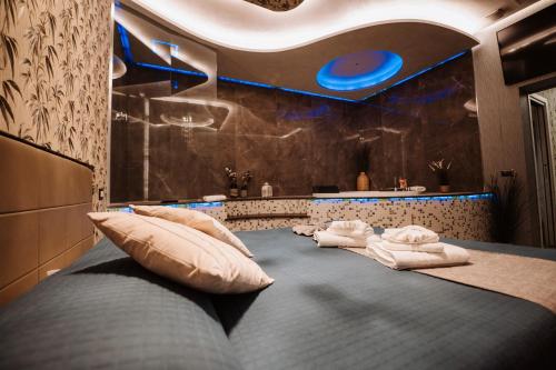 a room with a large bed with pillows on it at TH LUXURY SUITE in Giardini Naxos