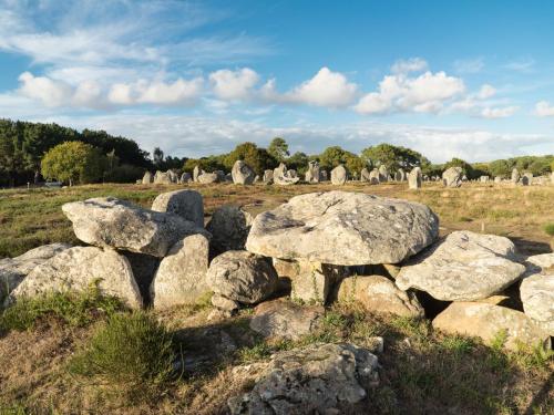 a group of rocks in a field with a cemetery at Holiday Home Kerdual by Interhome in La Trinité-sur-Mer