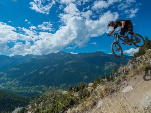 a man doing a trick on a bike in the air at Chalet Coquelicot by Interhome in Zinal