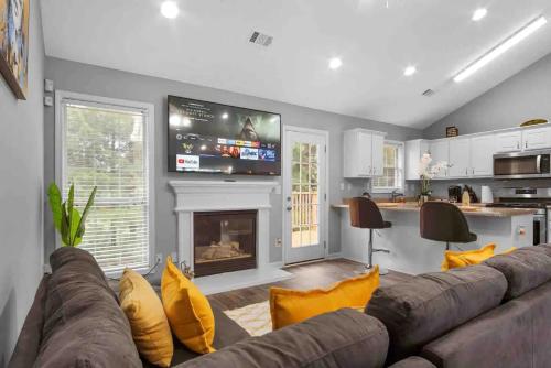 a living room with a couch and a fireplace at Unwind in a Modern Riverdale Home in Riverdale