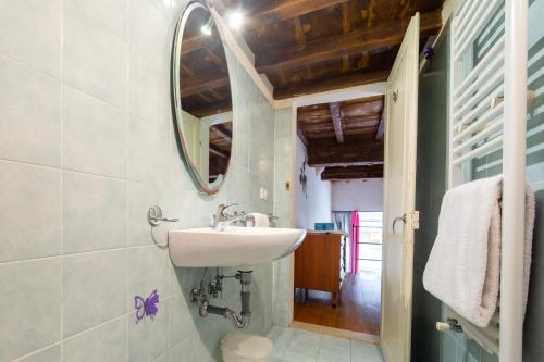 a bathroom with a sink and a mirror at Palazzo Vecchio Apartments by Mmega in Florence