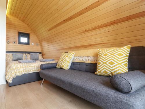 a living room with a couch and a wooden ceiling at Sun Rise in Penzance