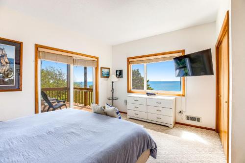a bedroom with a bed and a view of the ocean at Soaring High in Lincoln City