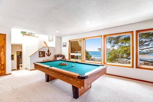a pool table in a room with a view of the ocean at Soaring High in Lincoln City