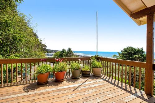 a row of potted plants sitting on a wooden deck at Soaring High in Lincoln City