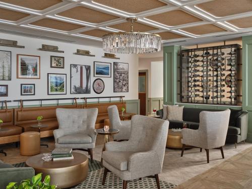 a lobby with chairs and tables and a chandelier at Six South St. Hotel in Hanover