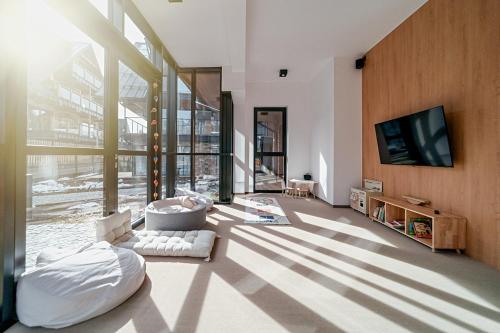 a living room with a large glass wall at Lipowy Dwór in Zakopane