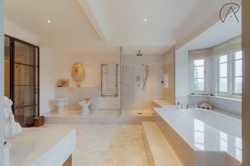 a large bathroom with a large tub and a shower at Luxury Rural Family Getaway with Tennis Court in Buckinghamshire