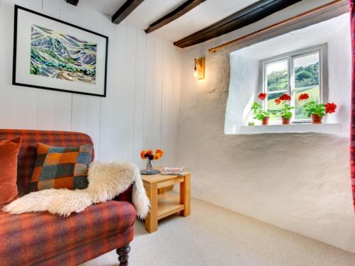 a living room with a couch and a window at Holiday Home Llety Clyd by Interhome in Dinas Mawddwy