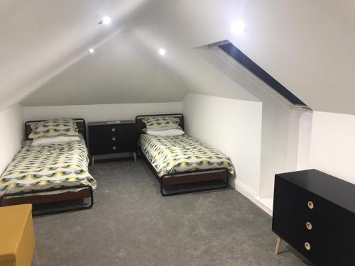 a room with two beds in a attic at Mallaig in Rockcliffe