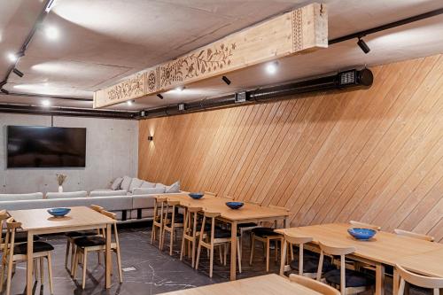 a room with wooden walls and tables and a couch at Lipowy Dwór in Zakopane